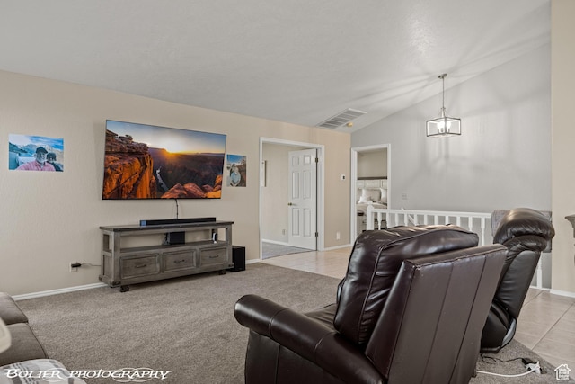 living area featuring visible vents, baseboards, and vaulted ceiling
