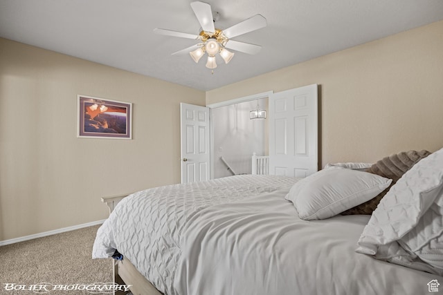 carpeted bedroom with baseboards and a ceiling fan