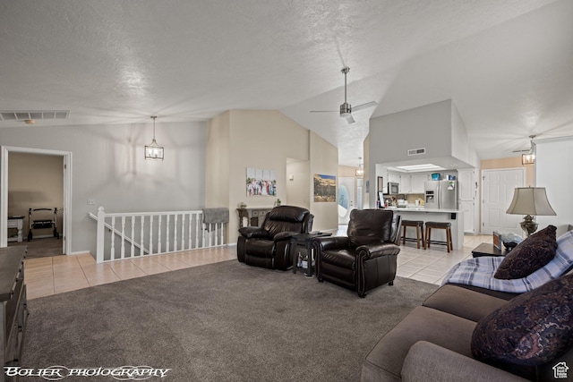 living room with visible vents, light colored carpet, and vaulted ceiling