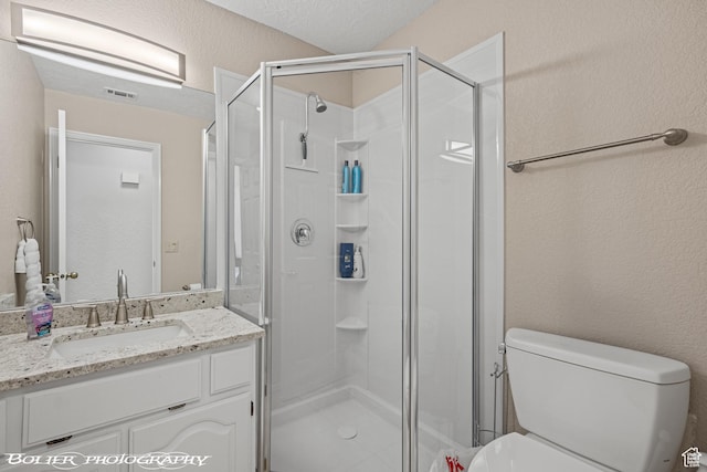 full bath featuring visible vents, toilet, a stall shower, and vanity