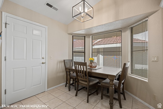 dining area with visible vents, baseboards, an inviting chandelier, and light tile patterned flooring
