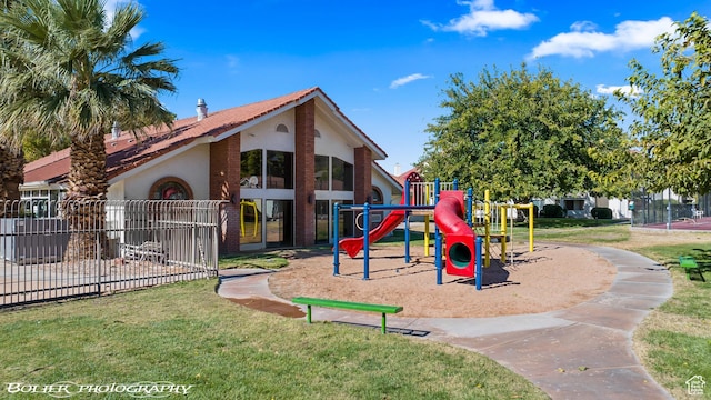 communal playground with fence and a lawn