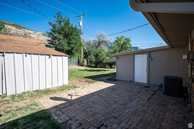 940 Fillmore Ave, Ogden, UT 84404 - view of patio / terrace with central AC unit, an outdoor structure, and a storage unit