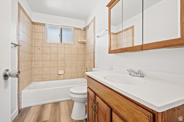 940 Fillmore Ave, Ogden, UT 84404 - full bathroom featuring vanity, toilet, wood finished floors, and bathtub / shower combination