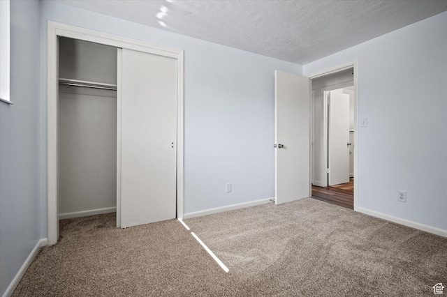 940 Fillmore Ave, Ogden, UT 84404 - unfurnished bedroom with carpet flooring, a closet, a textured ceiling, and baseboards
