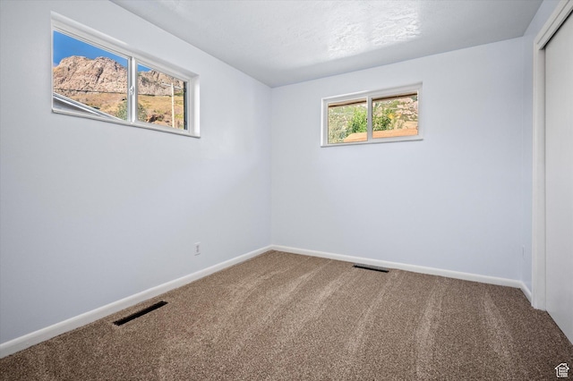 940 Fillmore Ave, Ogden, UT 84404 - unfurnished room featuring carpet, baseboards, and visible vents