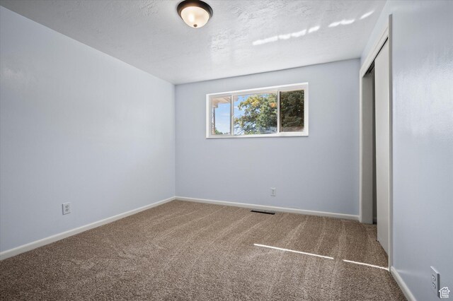 940 Fillmore Ave, Ogden, UT 84404 - unfurnished bedroom with a closet, visible vents, baseboards, and carpet floors