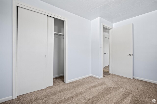 940 Fillmore Ave, Ogden, UT 84404 - unfurnished bedroom featuring baseboards, a closet, and carpet floors