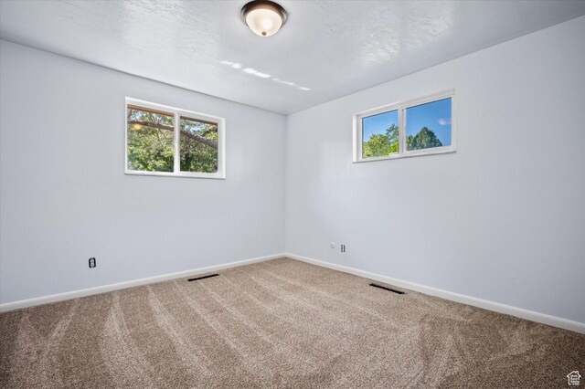 940 Fillmore Ave, Ogden, UT 84404 - carpeted spare room with visible vents, baseboards, and a healthy amount of sunlight