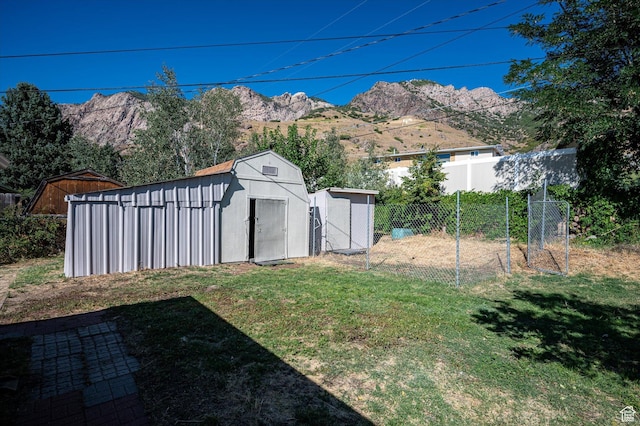 940 Fillmore Ave, Ogden, UT 84404 - view of yard featuring a mountain view, an outdoor structure, fence, and a shed