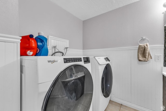 11873 S Coles Camp Cir W, Herriman, UT 84096 - washroom with laundry area, light tile patterned floors, a textured ceiling, separate washer and dryer, and wainscoting