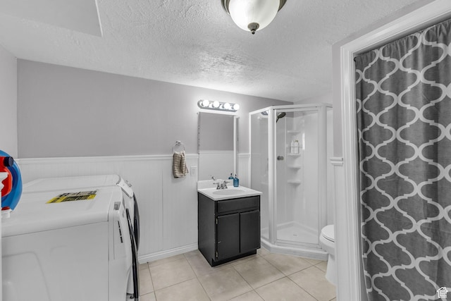 11873 S Coles Camp Cir W, Herriman, UT 84096 - bathroom with a textured ceiling, a shower stall, vanity, washing machine and dryer, and tile patterned flooring