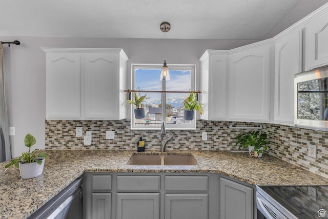 11873 S Coles Camp Cir W, Herriman, UT 84096 - kitchen with pendant lighting, white cabinetry, appliances with stainless steel finishes, a sink, and decorative backsplash