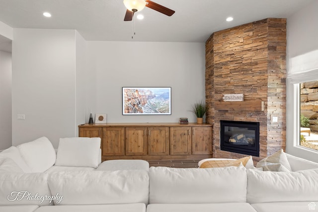 living area with ceiling fan, recessed lighting, and a fireplace