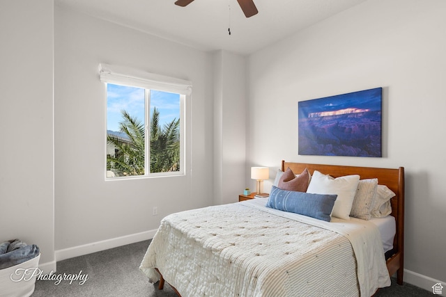 carpeted bedroom with ceiling fan and baseboards