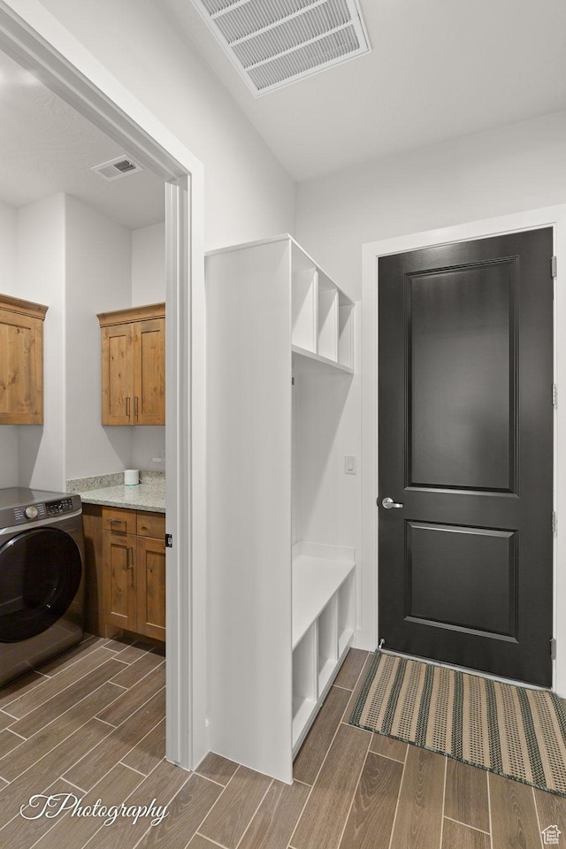 mudroom with washer / clothes dryer, wood finish floors, and visible vents