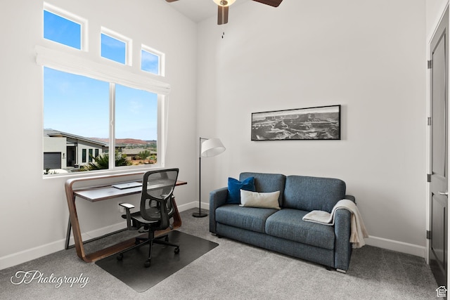 office area with ceiling fan, baseboards, and carpet