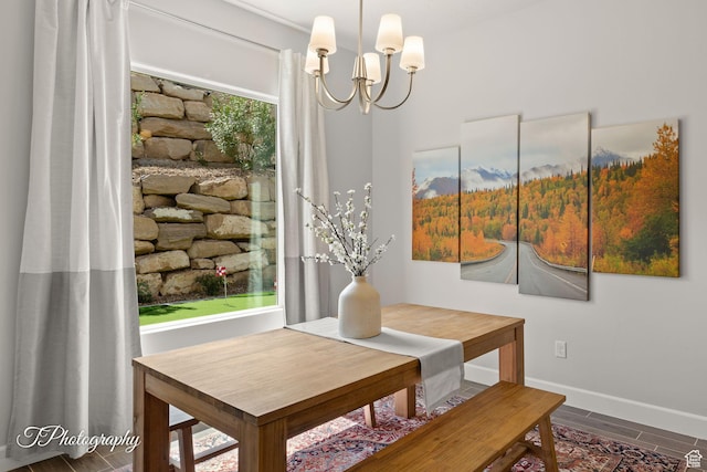 dining area with a notable chandelier and baseboards
