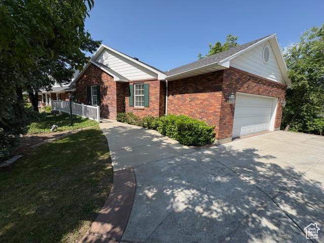 506 S 1200 E, Bountiful, UT 84010 - view of front facade featuring brick siding, concrete driveway, and a garage