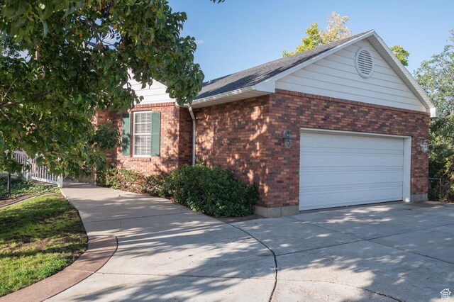 506 S 1200 E, Bountiful, UT 84010 - view of side of property featuring brick siding, a garage, and driveway
