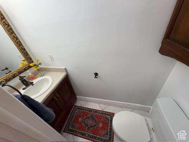 506 S 1200 E, Bountiful, UT 84010 - half bath featuring toilet, vanity, tile patterned floors, and baseboards