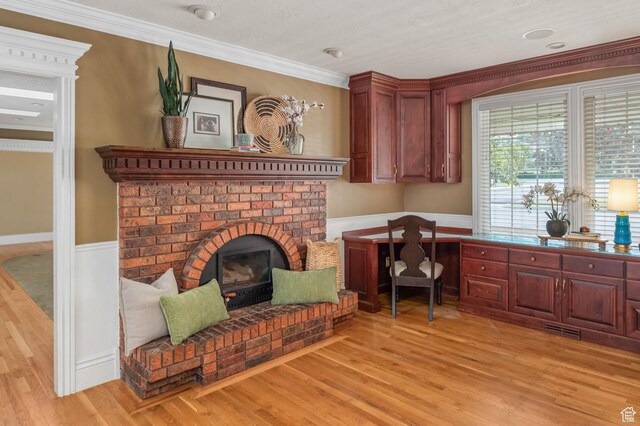 506 S 1200 E, Bountiful, UT 84010 - office featuring a fireplace, crown molding, a wainscoted wall, light wood-style floors, and visible vents