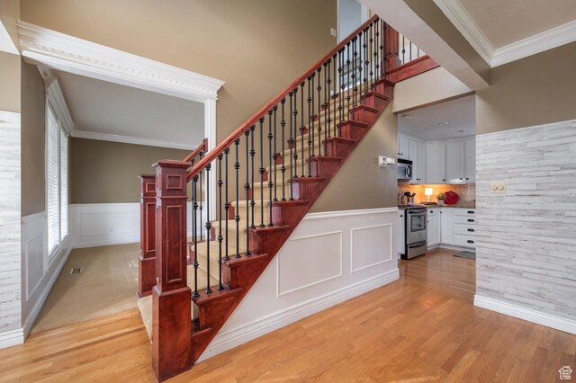 506 S 1200 E, Bountiful, UT 84010 - staircase featuring a decorative wall, wainscoting, wood finished floors, and crown molding