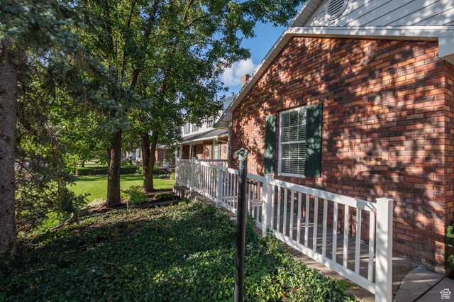 506 S 1200 E, Bountiful, UT 84010 - view of home's exterior featuring brick siding and a lawn
