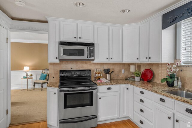 506 S 1200 E, Bountiful, UT 84010 - kitchen featuring stainless steel appliances, light stone countertops, and white cabinets