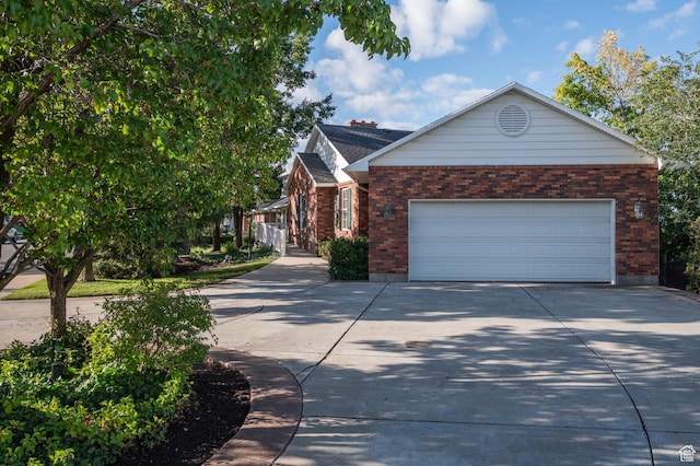 506 S 1200 E, Bountiful, UT 84010 - view of front of house with concrete driveway, roof with shingles, brick siding, and an attached garage