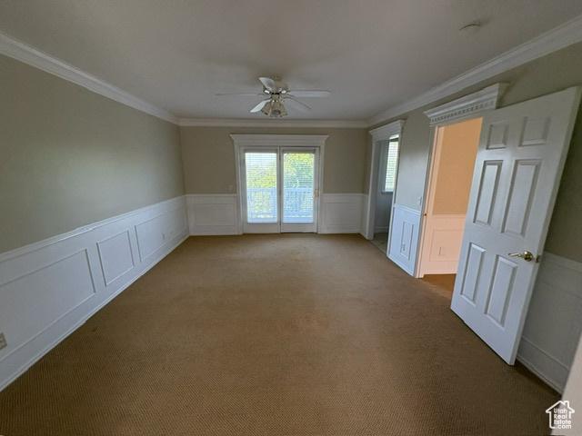506 S 1200 E, Bountiful, UT 84010 - carpeted spare room featuring ceiling fan, ornamental molding, wainscoting, and a decorative wall