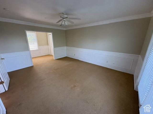 506 S 1200 E, Bountiful, UT 84010 - carpeted empty room with a ceiling fan, ornamental molding, wainscoting, and a decorative wall