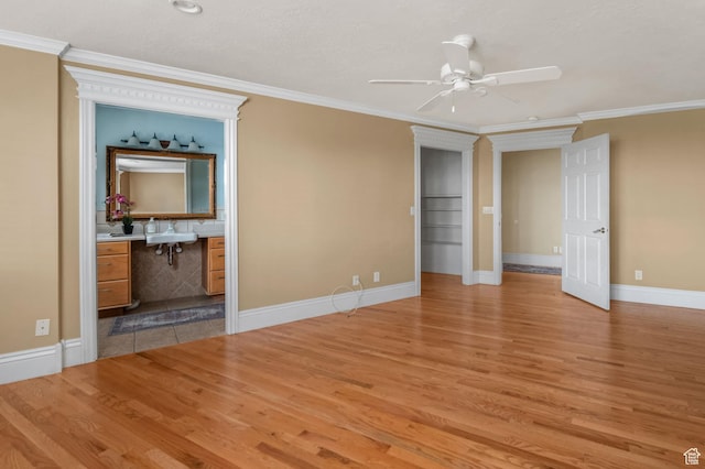 506 S 1200 E, Bountiful, UT 84010 - unfurnished bedroom featuring ensuite bathroom, baseboards, a sink, light wood-style floors, and crown molding