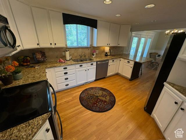 506 S 1200 E, Bountiful, UT 84010 - kitchen featuring dishwasher, electric range, black microwave, a sink, and light wood-type flooring