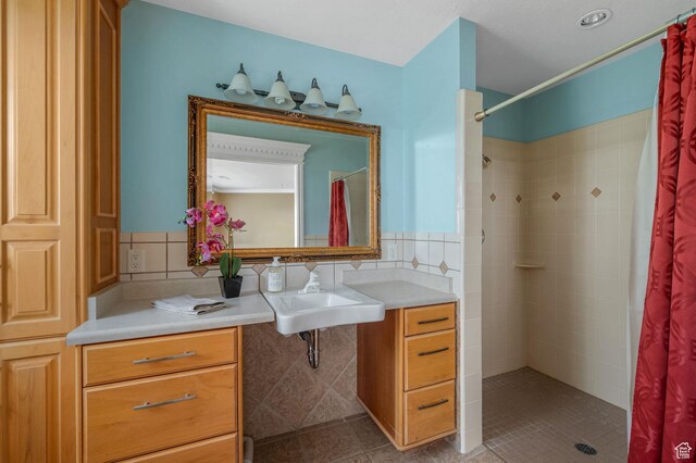 506 S 1200 E, Bountiful, UT 84010 - bathroom with tile patterned flooring, a sink, and a tile shower