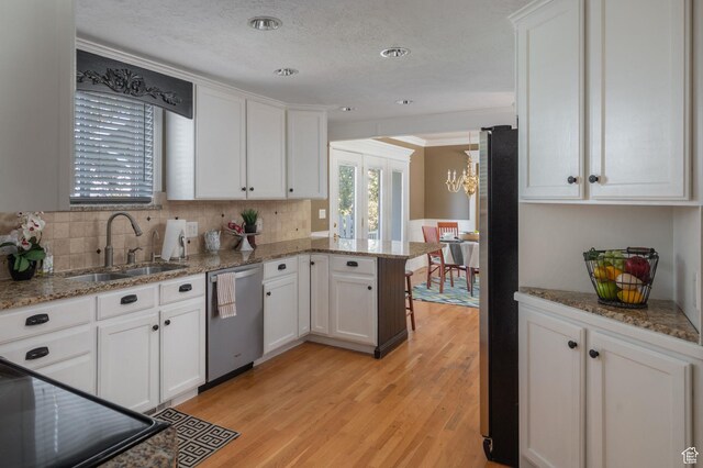 506 S 1200 E, Bountiful, UT 84010 - kitchen with an inviting chandelier, a sink, a peninsula, white cabinetry, and stainless steel appliances