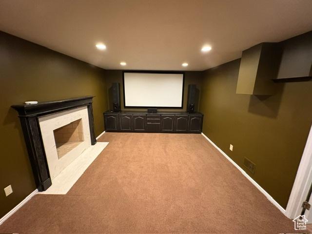 506 S 1200 E, Bountiful, UT 84010 - cinema room featuring a fireplace with flush hearth, recessed lighting, light colored carpet, and baseboards