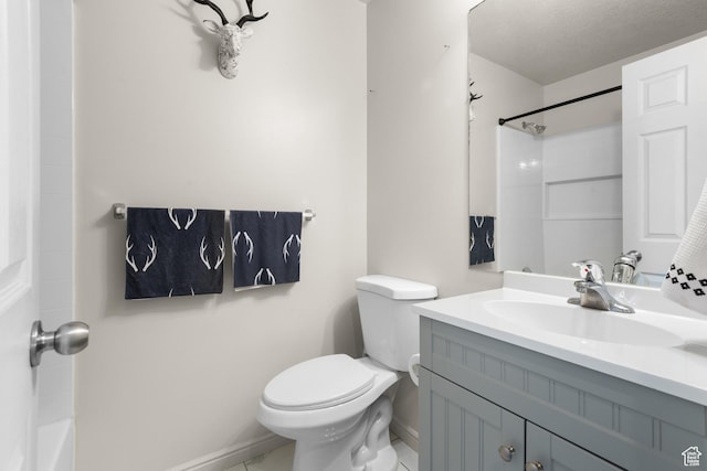 bathroom featuring toilet, vanity, and baseboards