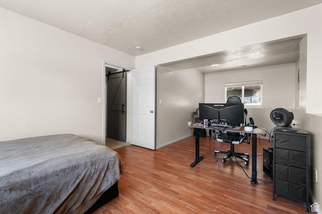 bedroom featuring wood finished floors and baseboards