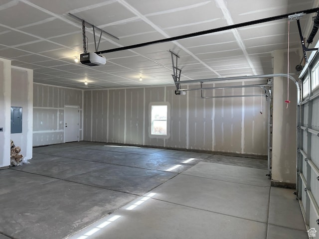 garage featuring electric panel and a garage door opener