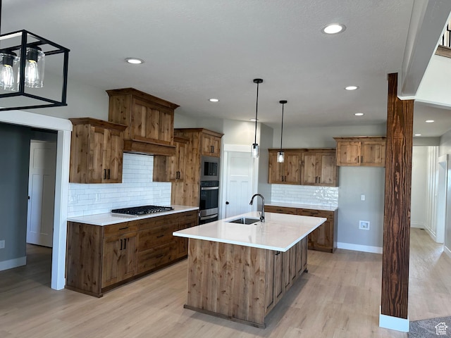 kitchen featuring stainless steel appliances, tasteful backsplash, brown cabinetry, and a sink