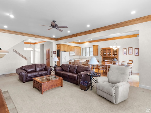 living area with baseboards, recessed lighting, crown molding, light colored carpet, and ceiling fan with notable chandelier