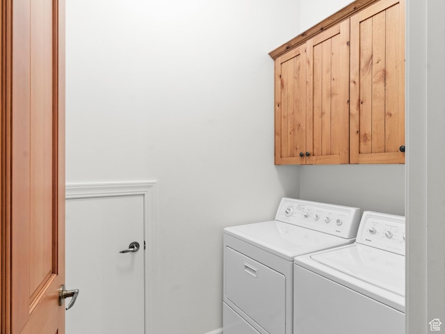 laundry room featuring washer and clothes dryer and cabinet space