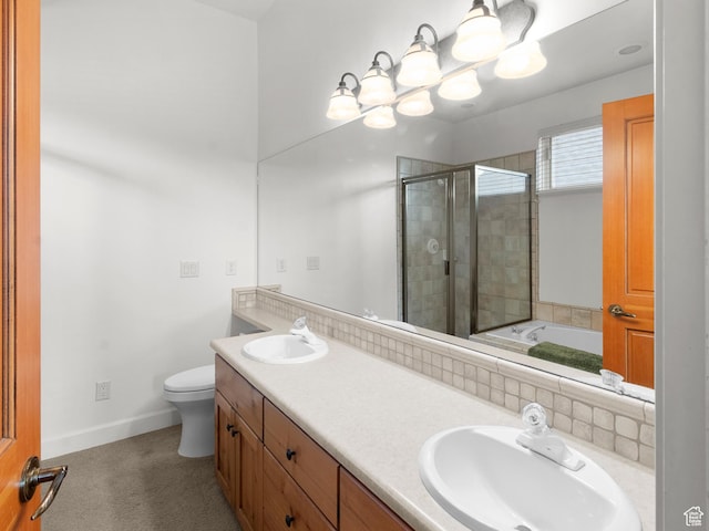 bathroom with a sink, toilet, a stall shower, and a notable chandelier