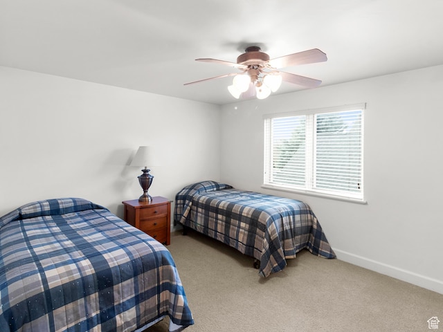 bedroom with baseboards, a ceiling fan, and carpet floors
