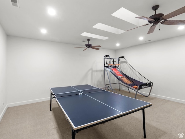 game room featuring a skylight, baseboards, a ceiling fan, and carpet floors