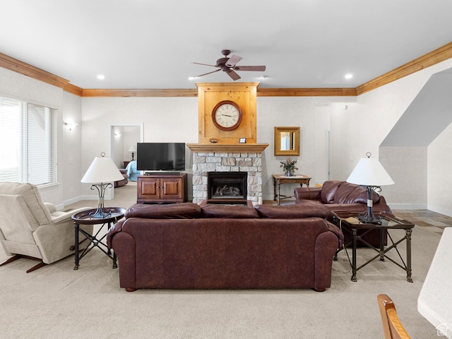 living room with baseboards, a stone fireplace, ornamental molding, ceiling fan, and light colored carpet