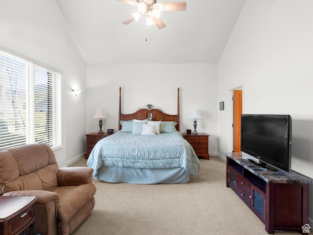 bedroom featuring high vaulted ceiling, light carpet, baseboards, and ceiling fan