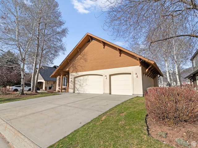 view of home's exterior with a garage, driveway, and stucco siding
