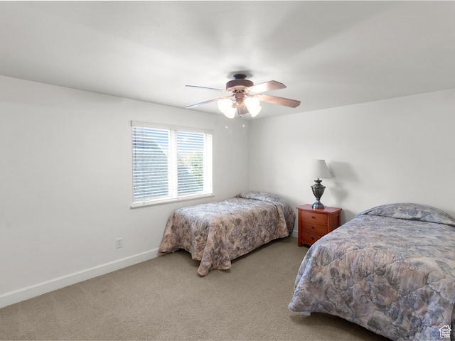 carpeted bedroom with baseboards and ceiling fan